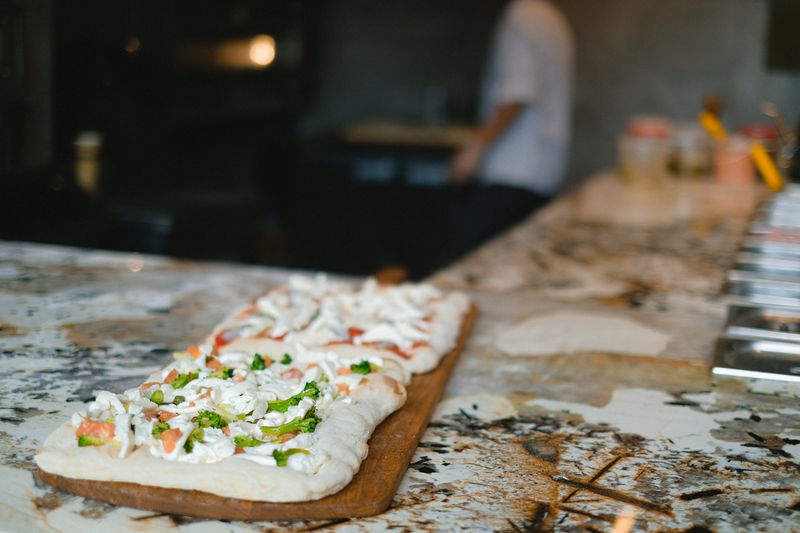 mod pizza fresh ingredients on a wooden table