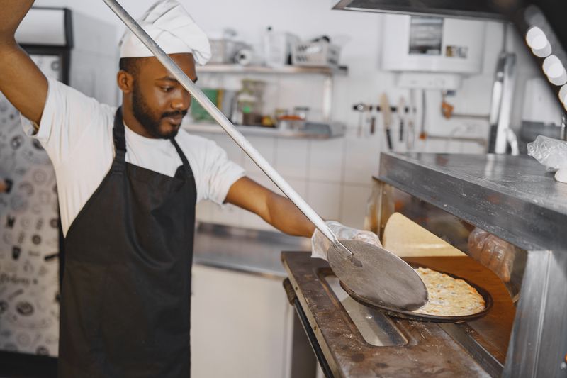 Mod Pizza team preparing food behind the counter